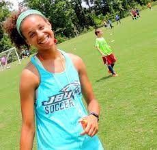Young girl smiling on soccer field