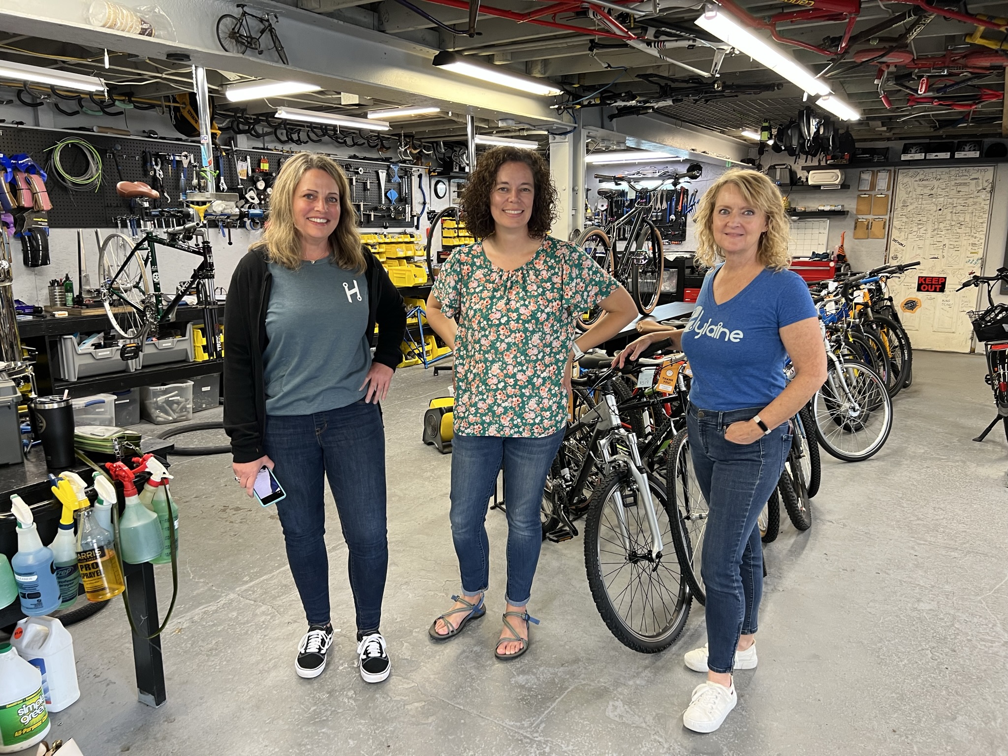 Hylaine volunteers on site at Bearings Bike Works with Bearings Co-Founder, Becky O'Mara.