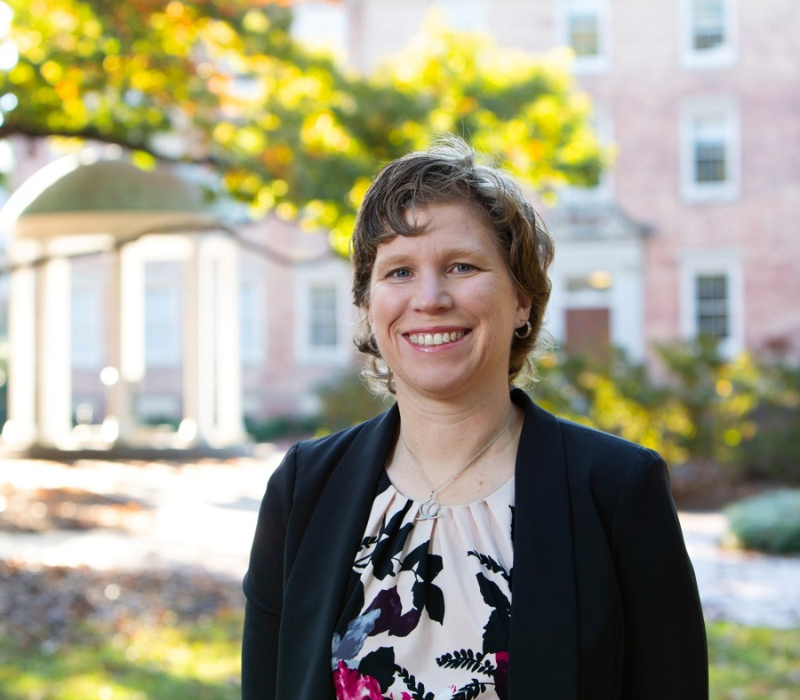 Rebecca DePasquale sitting under a tree.