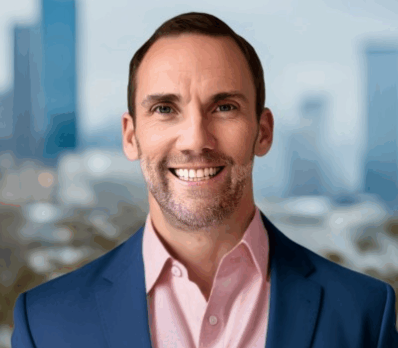 Headshot of Eric Hoffman with Charlotte in background